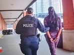 Picture shows Hoboken police cuffed one of the alleged 'shoplifters' Picture shows Hoboken police cuffed one of the alleged 'shoplifters'