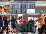Armed security policemen (L) patrol inside the terminal at Singapore Changi Airport in Singapore on April 15, 2024. (Photo by Roslan RAHMAN / AFP) Armed security policemen (L) patrol inside the terminal at Singapore Changi Airport in Singapore on April 15, 2024. (Photo by Roslan RAHMAN / AFP)