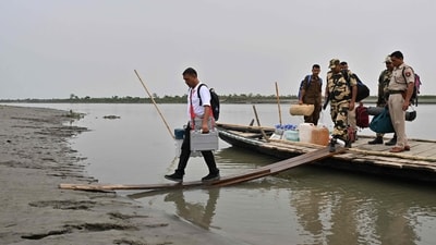 An election official carrying an Electronic Voting Machine (EVM) to a polling station, disembarks a boat on the eve of the first round of voting at Lohore Chapori in Golaghat, Assam. (AFP) An election official carrying an Electronic Voting Machine (EVM) to a polling station, disembarks a boat on the eve of the first round of voting at Lohore Chapori in Golaghat, Assam. (AFP)