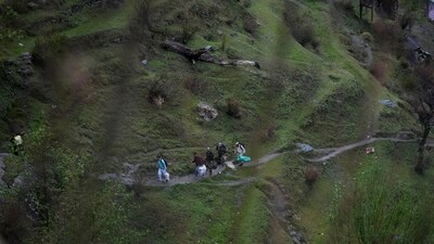 Election officials carrying polling material walk to a polling booth in a remote mountain area at Dessa village in Doda district, UT of Jammu and Kashmir. (AP) Election officials carrying polling material walk to a polling booth in a remote mountain area at Dessa village in Doda district, UT of Jammu and Kashmir. (AP)
