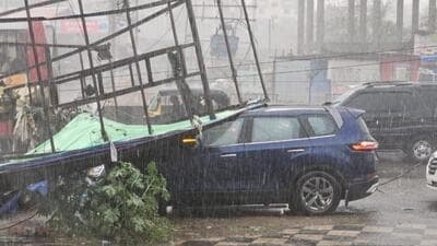 A hoarding outside a private vehicle showroom fell on a car at Ahmednagar Road and also damaged four to five other vehicles, according to the PMRDA fire brigade. (HT PHOTO) A hoarding outside a private vehicle showroom fell on a car at Ahmednagar Road and also damaged four to five other vehicles, according to the PMRDA fire brigade. (HT PHOTO)