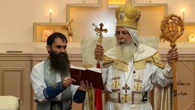 Bishop Mar Mari Emmanuel (right), who was stabbed at Christ the Good Shepherd church in Wakeley. (Reuters)