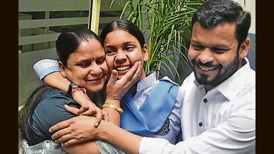 Aditi, who topped the PSEB exams, celebrates with her parents in Ludhiana on Thursday. (Gurpreet Singh/HT) Aditi, who topped the PSEB exams, celebrates with her parents in Ludhiana on Thursday. (Gurpreet Singh/HT)