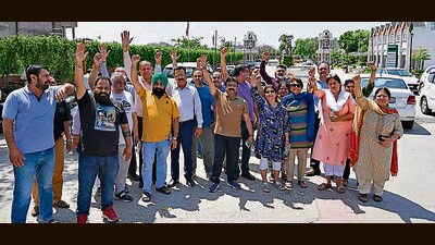 Eldeco residents during the protest on GT road in Ludhiana on Thursday. (Gurpreet Singh/HT)