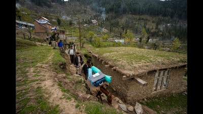 Election officials carrying polling material walk to a polling booth in a remote mountain area on the eve of the first round of voting in the six-week long national election at Dessa village in Doda district, Jammu and Kashmir on India. (AP) Election officials carrying polling material walk to a polling booth in a remote mountain area on the eve of the first round of voting in the six-week long national election at Dessa village in Doda district, Jammu and Kashmir on India. (AP)