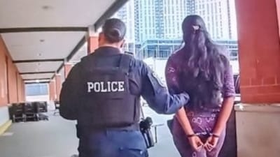 Picture shows Hoboken police cuffed one of the alleged 'shoplifters' Picture shows Hoboken police cuffed one of the alleged 'shoplifters'