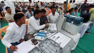 Election staff check the Electronic Voting Machines (EVM) at a polling station ahead of the first phase of polling on Friday. (Reuters)