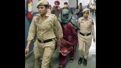 Police personnel taking Neelam Kaur, the murder convict, to court before the judgment was pronounced in Ludhiana on Thursday. (Gurpeet Singh/HT) Police personnel taking Neelam Kaur, the murder convict, to court before the judgment was pronounced in Ludhiana on Thursday. (Gurpeet Singh/HT)
