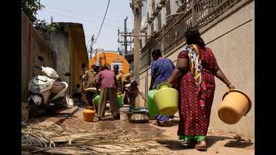 Residents arrive to get their containers filled with drinking water from a water tanker supplied by Bruhat Bengaluru Mahanagara Palike(BBMP) in Bengaluru. (REUTERS) Residents arrive to get their containers filled with drinking water from a water tanker supplied by Bruhat Bengaluru Mahanagara Palike(BBMP) in Bengaluru. (REUTERS)