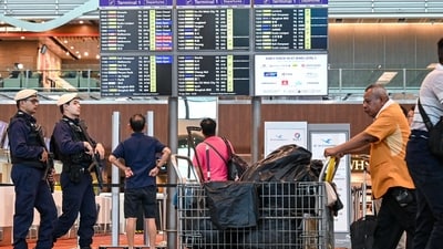 Armed security policemen (L) patrol inside the terminal at Singapore Changi Airport in Singapore on April 15, 2024. (Photo by Roslan RAHMAN / AFP) (AFP) Armed security policemen (L) patrol inside the terminal at Singapore Changi Airport in Singapore on April 15, 2024. (Photo by Roslan RAHMAN / AFP) (AFP)