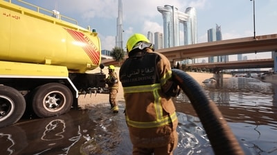 Members of the Dubai Civil Defence use a bowser to remove water from a flooded highway after a rainstorm in Dubai, United Arab Emirates. (Bloomberg) Members of the Dubai Civil Defence use a bowser to remove water from a flooded highway after a rainstorm in Dubai, United Arab Emirates. (Bloomberg)