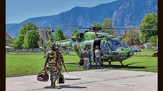 Security personnel and polling officials with election materials leaving for poll duty ahead of the first phase of Lok Sabha elections in Jammu and Kashmir on Thursday. (PTI)