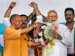 Prime Minister Narendra Modi being felicitated by Uttar Pradesh chief minister Yogi Adityanath during a public meeting for the Lok Sabha elections, at Gajraula in Amroha,(PTI)