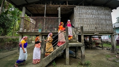 Deori tribal women move to a traditional Deori hut after casting their vote in Jorhat, Assam. (Anupam Nath / AP)