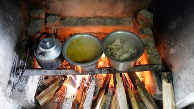 A meal of meat and lentils cook over an open fire, meant for polling officers on the eve of polling on Thursday, in Chedema village, Nagaland. (Yirmiyan Arthur / AP)
