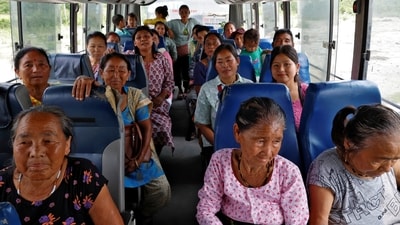 People who were relocated from Gangutia Basti, leave in a bus after casting their votes at a polling station inside Buxa Tiger Reserve forest in Alipurduar district, West Bengal. (Sahiba Chawdhary  / Reuters)