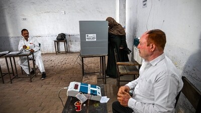 A voter casts a ballot at a polling station during the first phase of voting for national elections in Muzaffarnagar district, Uttar Pradesh. (Bloomberg)