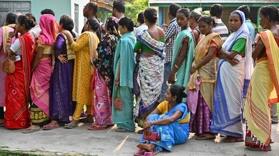 Voters line up to cast their votes as the first phase of India's general election begins at a polling station in Nagaon district, Assam. (AFP)