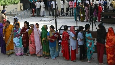 People stand in a queue to cast their ballot during the first phase of voting for the India's general election, at a polling station in Haridwar. (AFP)