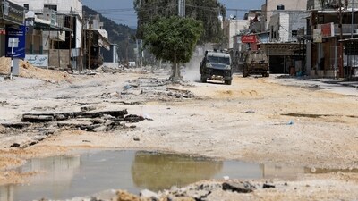 An Israeli military vehicle drives during a raid, at Nour Shams camp, in Tulkarm, in the Israeli-occupied West Bank. (Reuters)