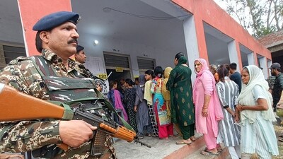 Security personnel stand guard as women arrive to cast their votes during Phase-I voting for the Lok Sabha elections 2024, in Kathua on Friday. (ANI Photo) (ANI) Security personnel stand guard as women arrive to cast their votes during Phase-I voting for the Lok Sabha elections 2024, in Kathua on Friday. (ANI Photo) (ANI)