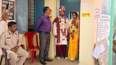 A newly-wedded couple at a polling station after casting their votes for the first phase of Lok Sabha elections, in Balaghat district. (PTI)