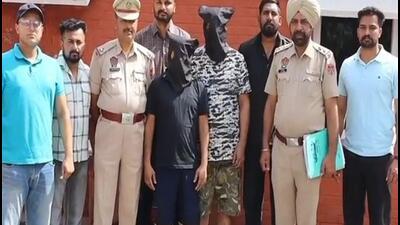 The two members of the Bambiha gang, Anil Kumar and Mukesh Sharma, in the custody of the Jalandhar Police on Friday. (ANI Photo)