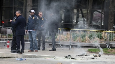 Emergency personnel work at the scene where a person was covered in flames outside the courthouse where former US President Donald Trump's criminal hush money trial is underway. (Reuters)