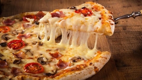 Avoid greasy or high-fat foods like pizza with a lot of cheese (Shutterstock) Avoid greasy or high-fat foods like pizza with a lot of cheese (Shutterstock)