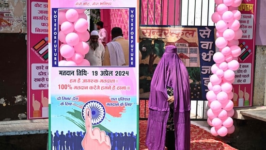 A burqa-clad woman waits to enter a polling station to cast her vote in the first phase of India's general election in Kairana, Shamli district, in Uttar Pradesh.(AFP)