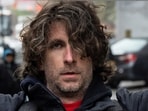 Max Azzarello of St. Augustine, Florida, who police identified as the man who set himself on fire on Friday outside the New York courthouse where Donald Trump's historic hush-money trial was taking place, holds a sign a day earlier outside the Manhattan criminal courthouse in New York City, New York, U.S., April 18, 2024. REUTERS/Caitlin Ochs