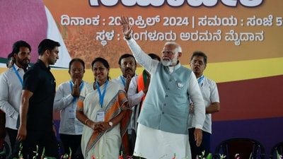 PM Narendra Modi waves towards his supporters as he arrives to attend an election campaign in Bengaluru, Karnataka. (REUTERS)