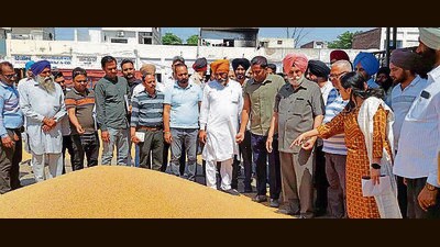 Markfed managing director Girish Dayalan, DC Sakshi Sawhney while inspecting wheat procurement operations at the Khanna grain market on Saturday. (HT Photo)