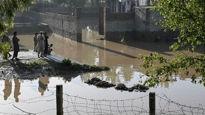 Residents stand near the flooded waters outside their homes following heavy rains in Charsadda district of Khyber Pakhtunkhwa province. (AFP) Residents stand near the flooded waters outside their homes following heavy rains in Charsadda district of Khyber Pakhtunkhwa province. (AFP)
