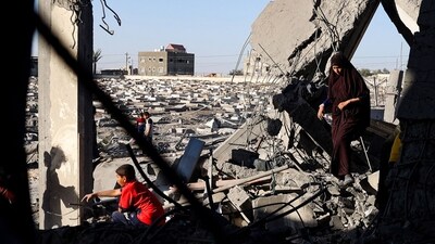 A Palestinian woman and children check the rubble of a building hit by overnight Israeli bombing in Rafah in the southern Gaza Strip on April 20, 2024, amid the ongoing conflict between Israel and the Hamas movement. (AFP) A Palestinian woman and children check the rubble of a building hit by overnight Israeli bombing in Rafah in the southern Gaza Strip on April 20, 2024, amid the ongoing conflict between Israel and the Hamas movement. (AFP)