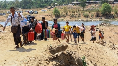 People cross the Moei river as they flee Myawaddy township in Myanmar to Thailand's Mae Sot town in Thailand's Tak province, Saturday, April 20, 2024. (AP) People cross the Moei river as they flee Myawaddy township in Myanmar to Thailand's Mae Sot town in Thailand's Tak province, Saturday, April 20, 2024. (AP)