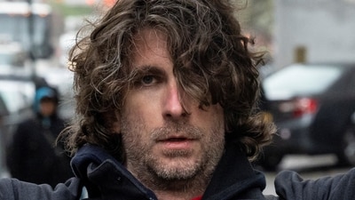 Max Azzarello of St. Augustine, Florida, who police identified as the man who set himself on fire on Friday outside the New York courthouse where Donald Trump's historic hush-money trial was taking place, holds a sign a day earlier outside the Manhattan criminal courthouse in New York City, New York, U.S., April 18, 2024. REUTERS/Caitlin Ochs (REUTERS)
