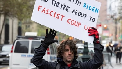 Max Azzarello of St. Augustine, Florida, who police identified as the man who set himself on fire on Friday outside the New York courthouse where Donald Trump's historic hush-money trial was taking place, holds a sign a day earlier outside the Manhattan criminal courthouse in New York City, New York, U.S., April 18, 2024. REUTERS/Caitlin Ochs (REUTERS)