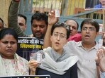 AAP leader Atishi with party workers carrying vials of insulin protest at gate no. 4 of Tihar jail on Sunday. (Vipin Kumar/HT Photo)