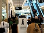 People walk on Community Reflection Day at Westfield Bondi Junction shopping centre as it re-opens to the public for the first time after the stabbing attacks which killed several people at the shopping centre, in Sydney, Australia