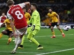 Arsenal's Martin Odegaard (L) scores their second goal during the match against Wolverhampton Wanderers at the Molineux stadium in Wolverhampton. Arsenal's Martin Odegaard (L) scores their second goal during the match against Wolverhampton Wanderers at the Molineux stadium in Wolverhampton.