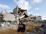 Palestinian children sit next to the site of an Israeli strike on a house, amid the ongoing conflict between Israel and the Palestinian Islamist group Hamas, in Rafah, in the southern Gaza Strip, April 21, 2024.