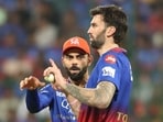 Royal Challengers Bengaluru's Virat Kohli speaks to bowler Reece Topley 