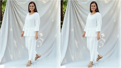 Her outfit comes in an alluring shade of white and features a scoop neck top with dropped shoulders and shell button detailing. She teamed it with matching trousers that have a frayed hem, an elasticated waist and a slim shell tassel belt detail. (Instagram/@diamirzaofficial) Her outfit comes in an alluring shade of white and features a scoop neck top with dropped shoulders and shell button detailing. She teamed it with matching trousers that have a frayed hem, an elasticated waist and a slim shell tassel belt detail. (Instagram/@diamirzaofficial)