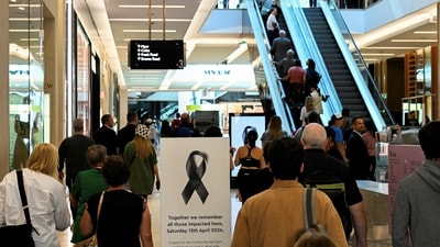 People walk on Community Reflection Day at Westfield Bondi Junction shopping centre as it re-opens to the public for the first time after the stabbing attacks which killed several people at the shopping centre, in Sydney, Australia (REUTERS)