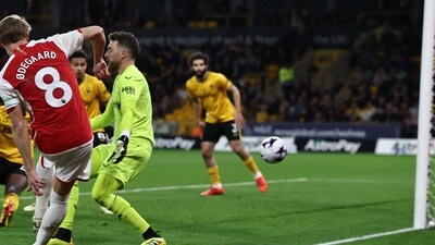 Arsenal's Martin Odegaard (L) scores their second goal during the match against Wolverhampton Wanderers at the Molineux stadium in Wolverhampton. (AFP) Arsenal's Martin Odegaard (L) scores their second goal during the match against Wolverhampton Wanderers at the Molineux stadium in Wolverhampton. (AFP)