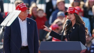 (L-R) Former US President and Republican presidential candidate Donald Trump listens as North Dakota Governor Kristi Noem speaks during a Buckeye Values PAC Rally in Vandalia, Ohio, on March 16, 2024. (Photo by KAMIL KRZACZYNSKI / AFP) (AFP) (L-R) Former US President and Republican presidential candidate Donald Trump listens as North Dakota Governor Kristi Noem speaks during a Buckeye Values PAC Rally in Vandalia, Ohio, on March 16, 2024. (Photo by KAMIL KRZACZYNSKI / AFP) (AFP)
