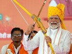 Prime Minister Narendra Modi holds a bow and an arrow during a public meeting in support of BJP candidate Mahendrajeet Singh Malviya for the Lok Sabha polls, in Banswara on Sunday. Prime Minister Narendra Modi holds a bow and an arrow during a public meeting in support of BJP candidate Mahendrajeet Singh Malviya for the Lok Sabha polls, in Banswara on Sunday.