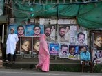 A woman walks past a wall filled with campaign posters of various candidates contesting in India’s parliamentary elections at the Thiruvananthapuram constituency, southern Kerala state, Monday, April 22, 2024. The state goes to polls on April 26. (AP Photo/Manish Swarup)