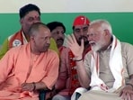 Prime Minister Narendra Modi in conversation with Uttar Pradesh Chief Minister Yogi Adityanath at a public meeting in Aligarh. 